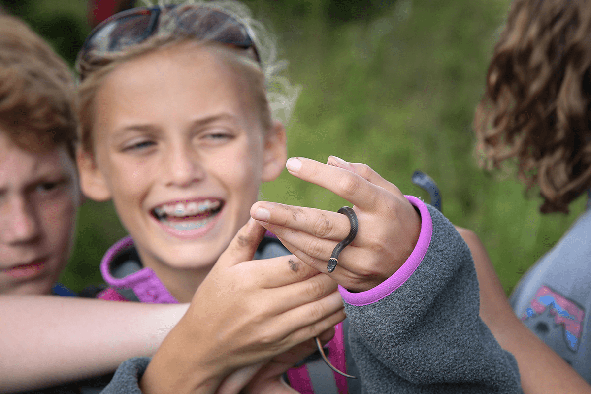 Image of a girl holding a baby snake